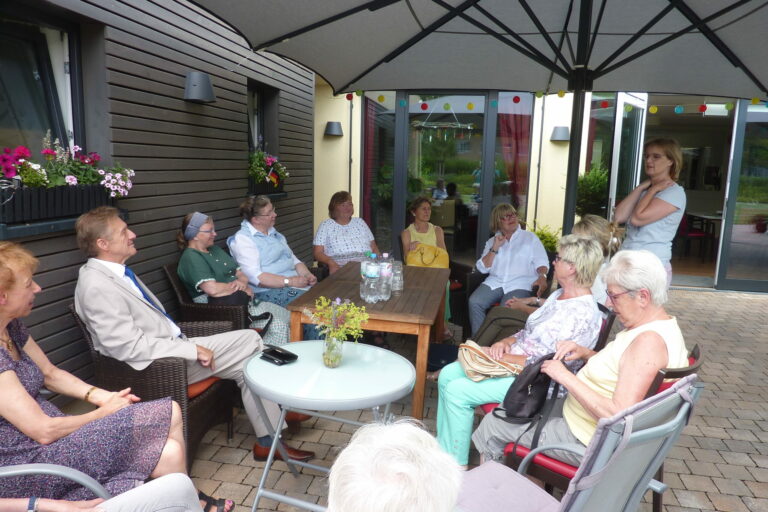 Besucher bei einem Besuch des Hospizes auf der Terrasse